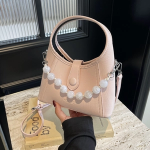 Pink faux leather handbag with pearl bead chain and adjustable shoulder strap for women