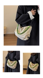 Detail of beige dumpling bag featuring neon green rope accents and adjustable strap