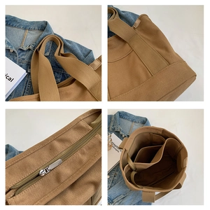 Detail showing brown canvas tote bag with reinforced handles, zipper and multi-layer interior