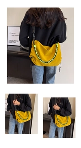 Detailed view of yellow nylon crossbody bag featuring woven chain and drawstring design