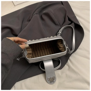 Detailed interior of a silver butterfly bag with striped lining and stud accents