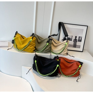Detailed view of nylon messenger bags in five colors with woven chains and drawstring accents