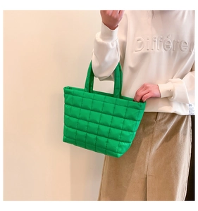 Detailed view of vibrant green quilted tote bag with elegant diamond stitching texture