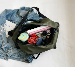 Top view of open olive green travel bag showing large capacity for laptop and essentials