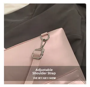 Detail of adjustable strap with silver metal buckle on a pink leather backpack