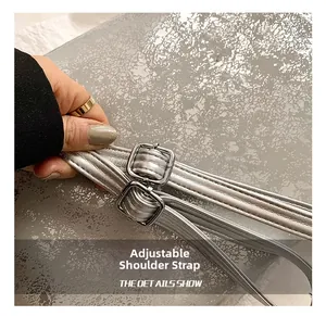 Close-up of adjustable silver metallic leather strap with square buckles for tote bags