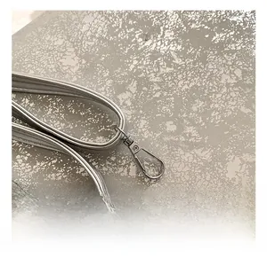 Close-up of polished silver alloy spring hook connector on the handbag strap