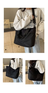 Detail view of black Oxford fabric tote bag showing dual shoulder straps and spacious design