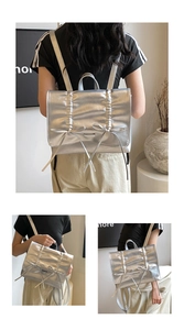 Detail of silver metallic backpack with pleated texture and decorative bows for women