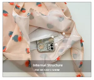 Detail of the pink tote bag interior featuring a zipper pocket and mobile phone slot