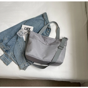 Detail of grey oxford tote bag showing durable fabric handles and adjustable strap