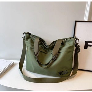 Detail of olive green large capacity nylon tote bag with NOCO logo and wide shoulder strap
