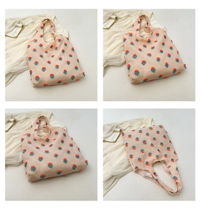 Close-up of pink tote bag with 3D floral embroidery and textured woven fabric detail