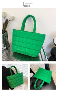 Detail view of large green quilted tote bag with checkered stitching and soft texture