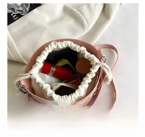 Internal view of pink hollow bucket bag showing capacity for cosmetics and power bank