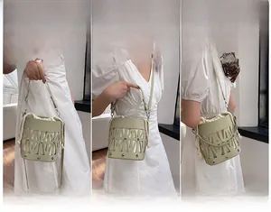 Green cutout bucket bag shown in three styles: handheld, crossbody, and shoulder carry