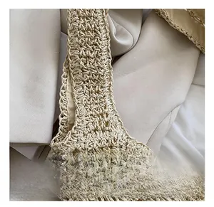 Macro shot of handcrafted straw tote bag handle attachment with intricate woven texture