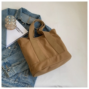 Detail of khaki canvas tote bag with reinforced wide bottom for high capacity storage