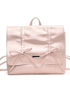 Pink pleated faux leather backpack with bow details and metal buckle on white background