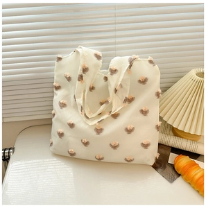 Detailed close-up of cream floral tote bag with soft fabric and small tulip patterns