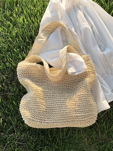 Handwoven straw tote bag for summer beach holidays featuring natural beige texture