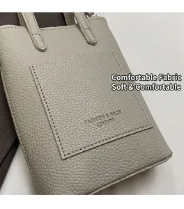 Close-up of light gray lychee grain leather bucket bag with fashion textured detail