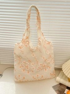 Floral embroidered tote bag in white mesh fabric with daisy patterns and long handles