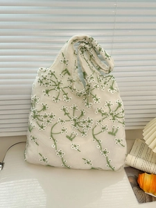 Minimalist white mesh tote bag with green and white floral embroidery for summer style