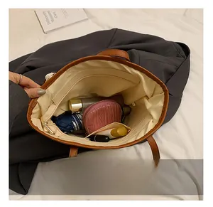 Interior view of spacious straw tote bag showing compartments and cream fabric lining