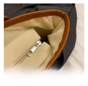 Detail of premium silver metal zipper and precise stitching on straw tote interior