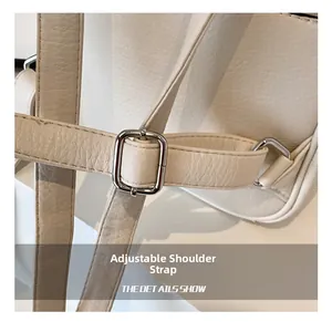 Detail of adjustable shoulder strap on off-white leather backpack with silver buckle