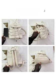 Detail view showing pleated leather texture, drawstring beads and four-sided backpack angles