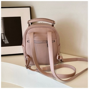 Detail of the pink leather backpack back with adjustable straps and anti-theft zipper pocket