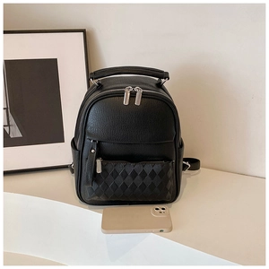 Detail of black pebbled leather mini backpack with quilted pocket and size scale