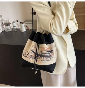 Detail der Strick-Beuteltasche mit Landschaftsmuster und Kordelzugverschluss an der Schulter