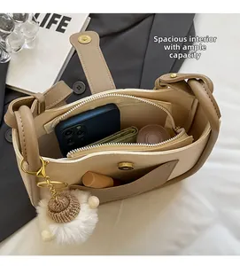 Detail view of the spacious inner compartment and lining of this cream bucket bag