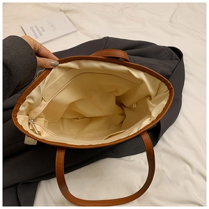 Top view showing spacious interior with zipper pocket of this brown leather tote bag