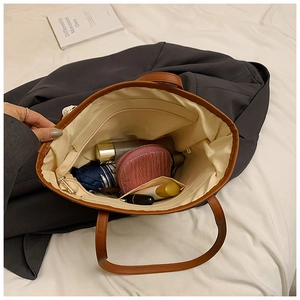 Interior view of straw tote bag showing large capacity for umbrella and cosmetics