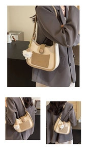 Detail of Korean contrast bucket bag in beige PU leather with cute sheep charm