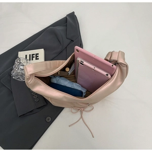 Top view showing large capacity interior of a light pink satin crescent hobo tote bag