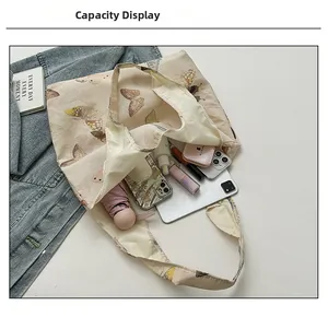 Top view of beige tote bag showcasing large capacity with daily items and tablet