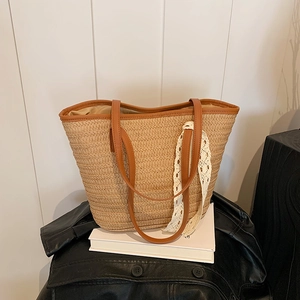 Summer woven straw tote bag with brown leather handles and white lace ribbon decoration