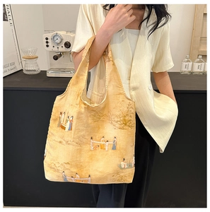 Artistic tote bag with traditional Chinese painting design shown in a lifestyle setting