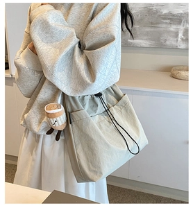 Detail of nylon tote bag with drawstring closure and cute coffee cup pendant