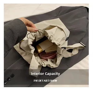 Macro shot of spacious beige nylon tote bag interior with multiple personal essentials