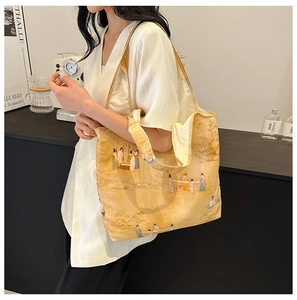 Detail of canvas tote bag featuring classic Chinese style painting with wide shoulder strap