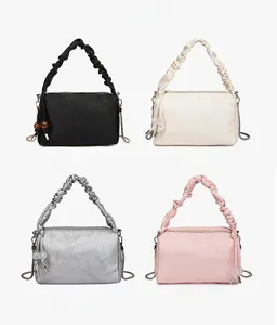 Detail view of the four elegant colors available for this floral textured handbag