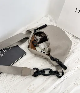 Top-down view of spacious canvas sling bag interior with phone and beauty essentials