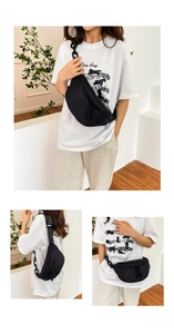 Detail of black crescent canvas chest bag with matte chain strap and dual zipper close