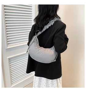Light gray puffy hobo cloud bag with unique adjustable ruffled strap detail